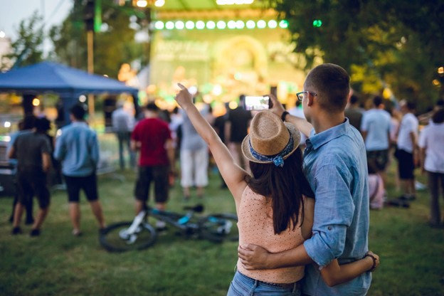 A couple enjoying a live music event with a crowd