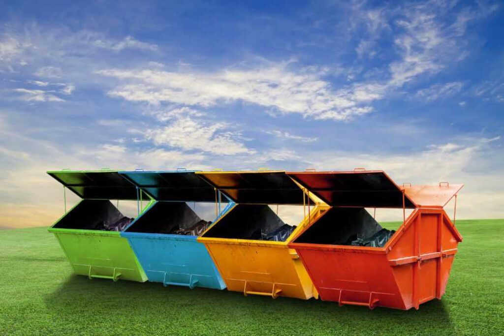 Three Vibrant Trash Containers Stand on a Grassy Field in Chicago, IL
